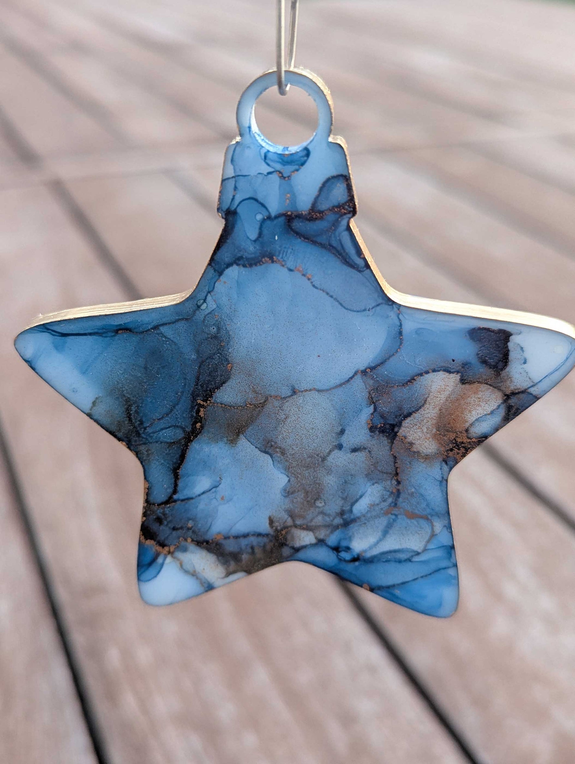 Star-shaped blue pendant on a wooden surface