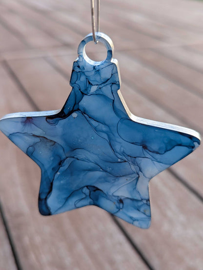 Blue marbled star-shaped object on a wooden surface
