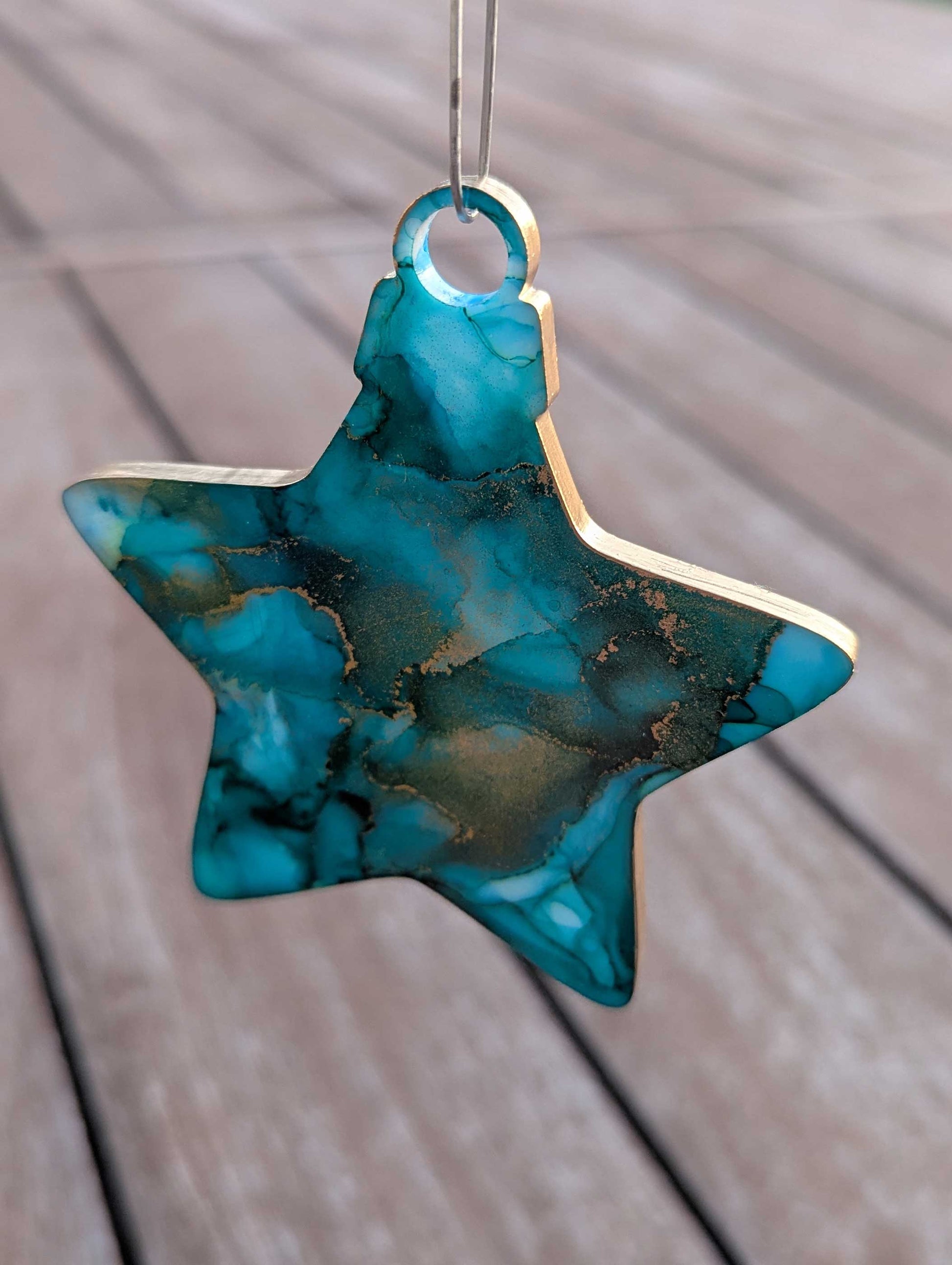 Star-shaped turquoise ornament on a wooden surface