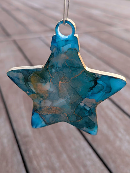 Turquoise star-shaped ornament on a wooden surface