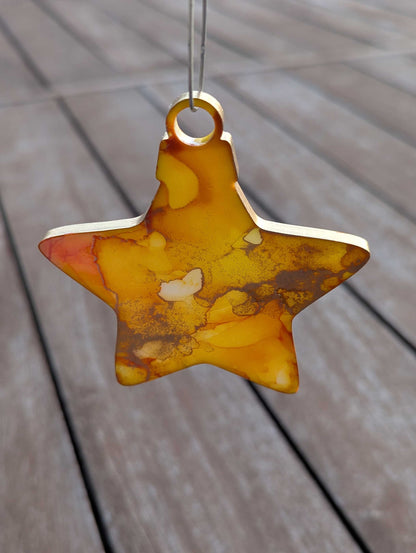 Star-shaped decorative item with a marbled design on a wooden surface