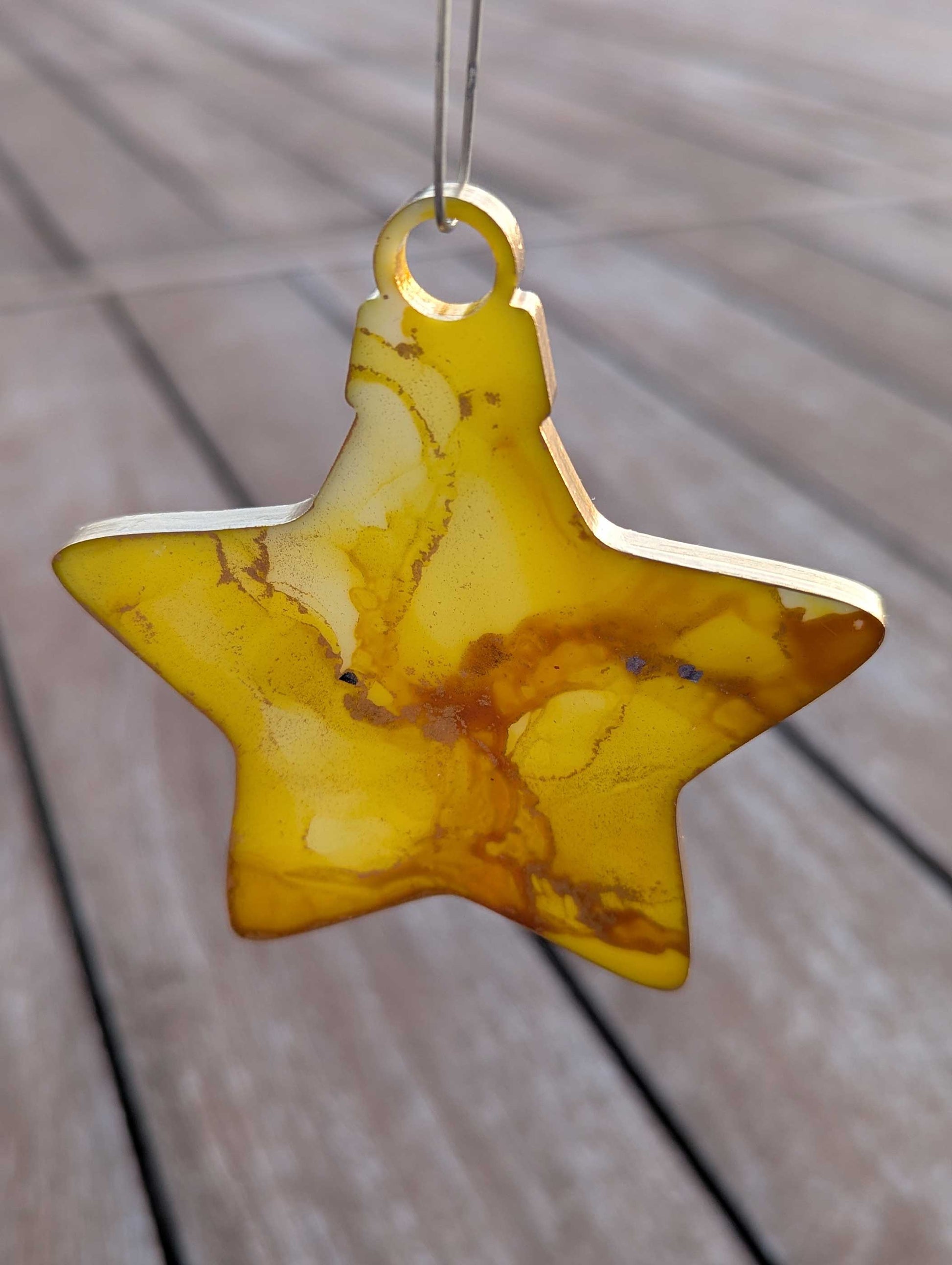 Star-shaped yellow ornament on a wooden surface