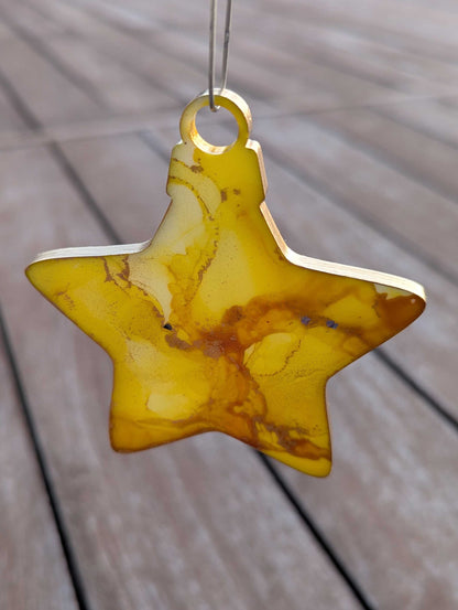 Star-shaped yellow ornament on a wooden surface
