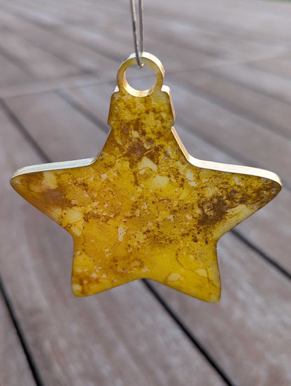Star-shaped yellow ornament on a wooden surface