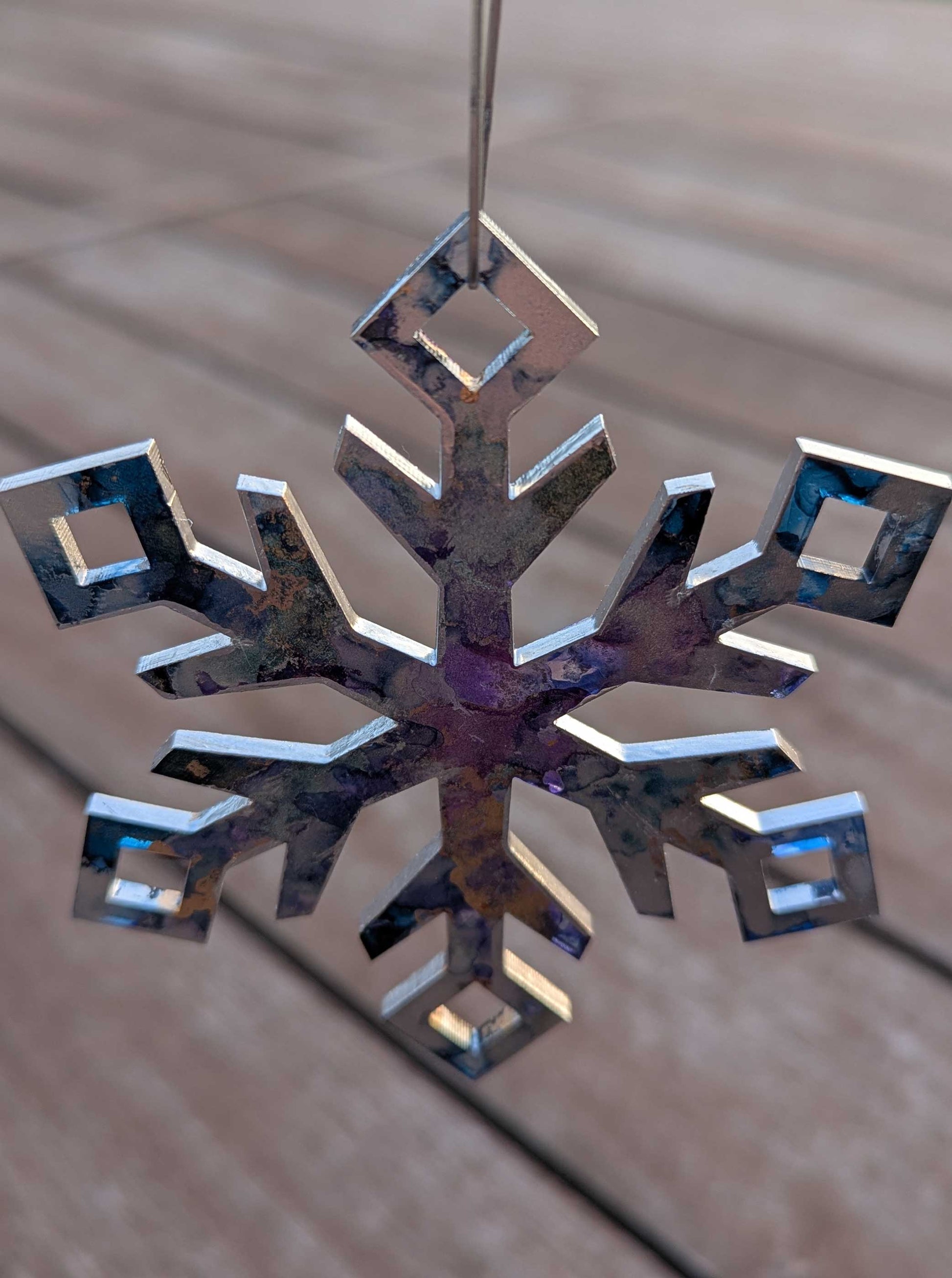 Decorative snowflake ornament on a wooden surface