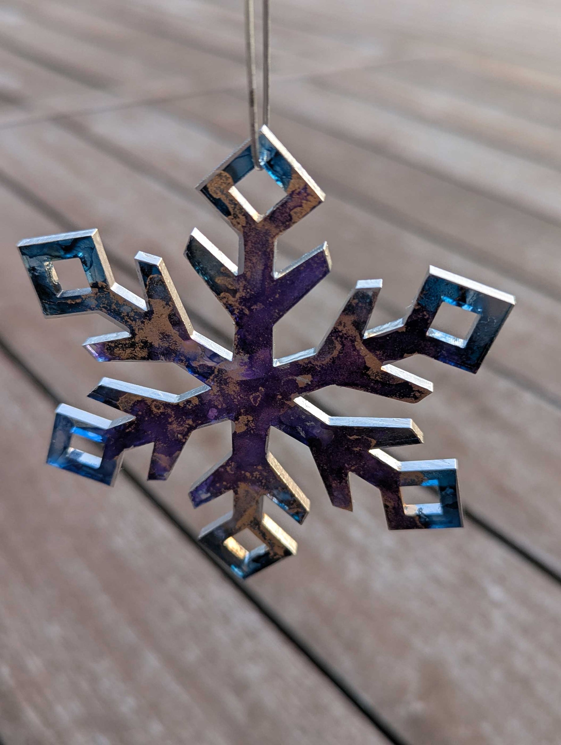 Decorative snowflake ornament on a wooden surface
