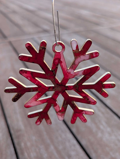 Red snowflake ornament on a wooden surface
