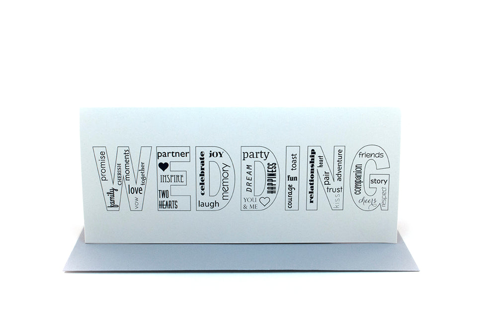 Greeting card standing upright on top of a colorful envelope against a white background.